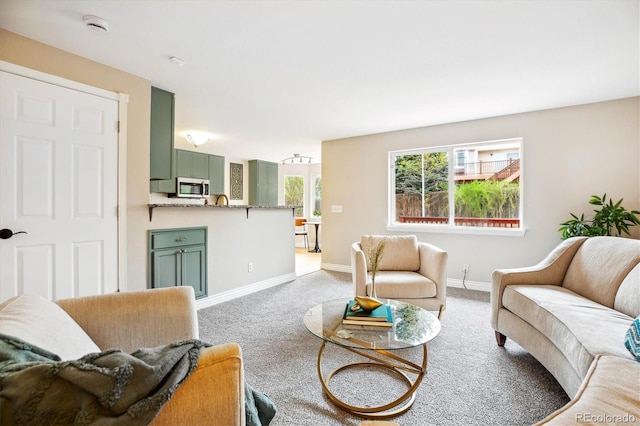 carpeted living room featuring baseboards