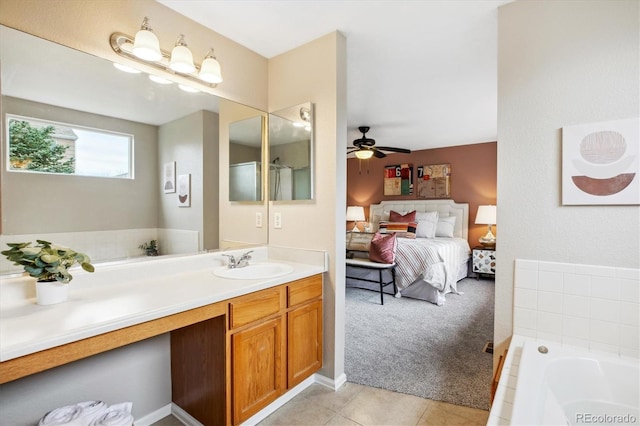 bathroom with connected bathroom, ceiling fan, vanity, tile patterned floors, and a bath