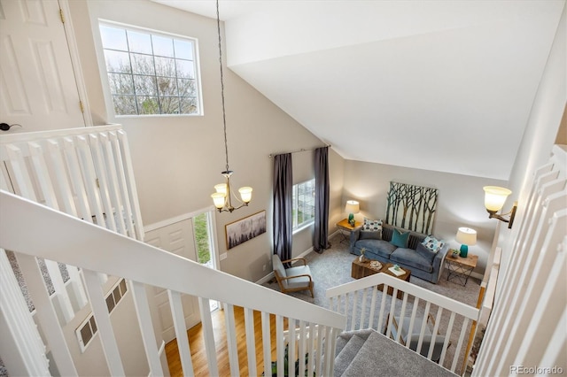 stairs with visible vents and a notable chandelier