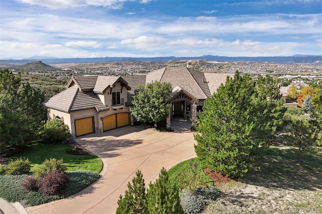 view of front of house featuring a garage and a mountain view