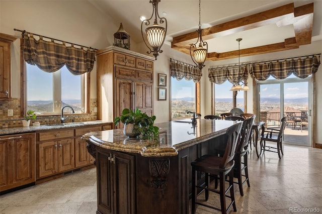 kitchen with stone counters, a center island, and a mountain view