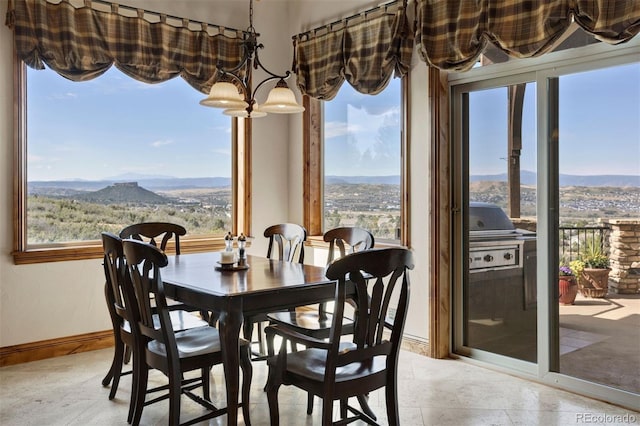 dining room with an inviting chandelier and a mountain view