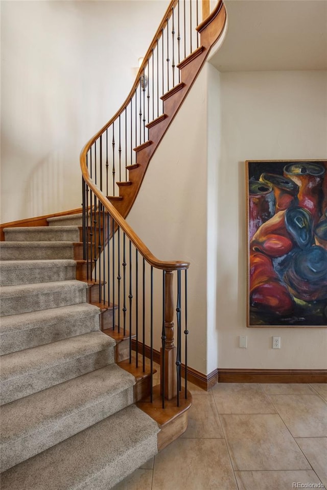 stairway featuring tile patterned flooring