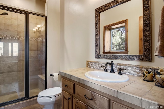 bathroom with vanity, an enclosed shower, and toilet