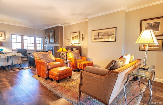 living area with ornamental molding, a glass covered fireplace, and wood finished floors