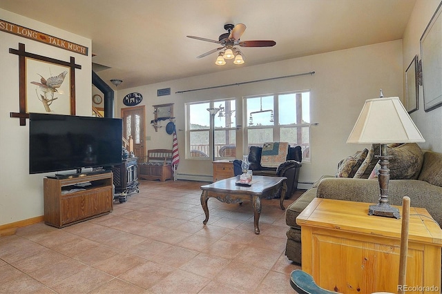 tiled living room with baseboard heating and ceiling fan