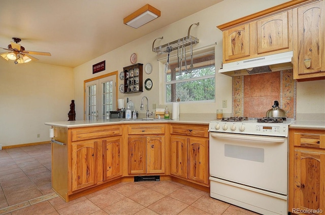 kitchen with gas range gas stove, light tile patterned floors, ceiling fan, french doors, and sink