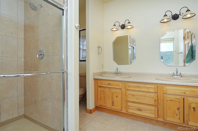 bathroom with toilet, tile patterned flooring, walk in shower, and vanity