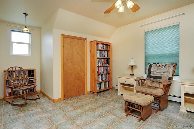 living area featuring lofted ceiling, a baseboard heating unit, and ceiling fan