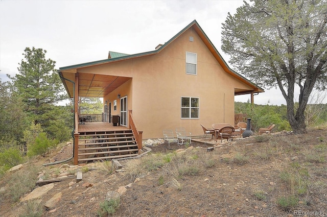 back of property featuring a fire pit