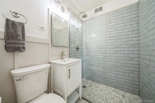 bathroom featuring visible vents, toilet, walk in shower, and vanity