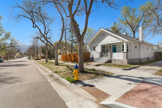 1130 E Yampa St, Colorado Springs, CO 80903 - view of front facade with fence, a porch, and driveway