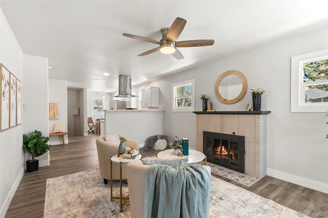 1130 E Yampa St, Colorado Springs, CO 80903 - living room featuring ceiling fan, a tile fireplace, baseboards, and wood finished floors