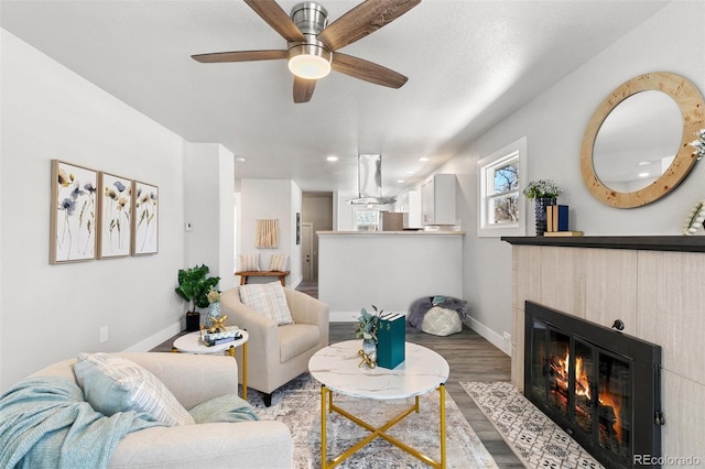 1130 E Yampa St, Colorado Springs, CO 80903 - living room featuring a fireplace with flush hearth, recessed lighting, wood finished floors, a ceiling fan, and baseboards