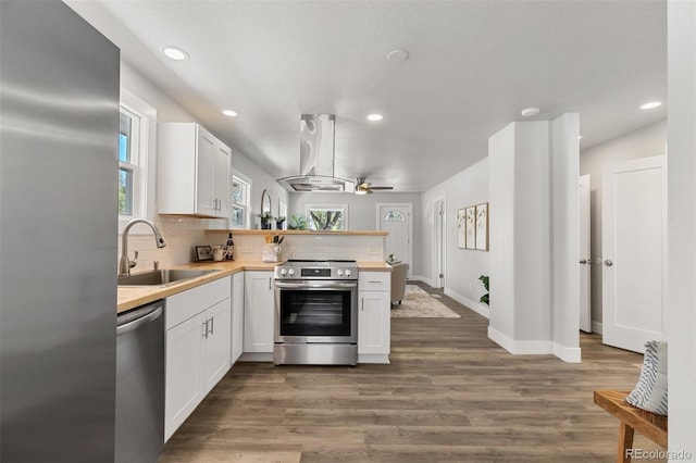 1130 E Yampa St, Colorado Springs, CO 80903 - kitchen with island exhaust hood, a ceiling fan, a sink, a peninsula, and appliances with stainless steel finishes