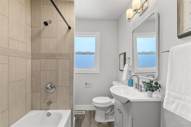 1130 E Yampa St, Colorado Springs, CO 80903 - bathroom with toilet, visible vents, wood finished floors, vanity, and shower / tub combination