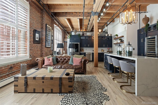 living room featuring light hardwood / wood-style floors, a healthy amount of sunlight, and brick wall