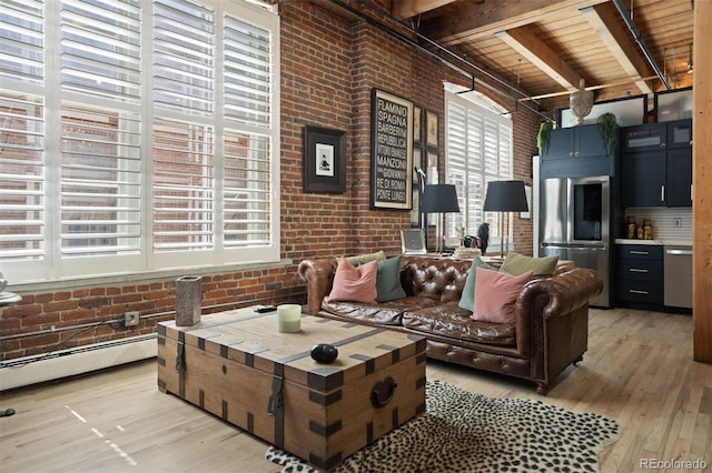 living room with light wood-type flooring, brick wall, and a healthy amount of sunlight