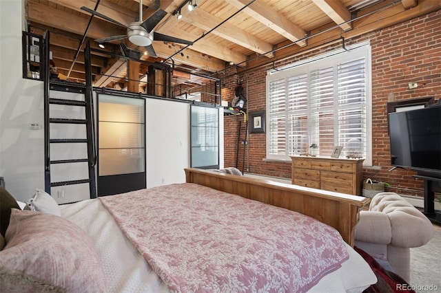 bedroom featuring beam ceiling, wooden ceiling, and brick wall