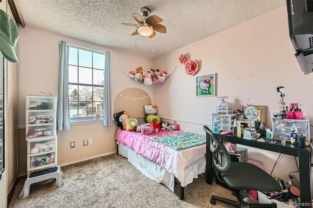 carpeted bedroom featuring a textured ceiling and ceiling fan