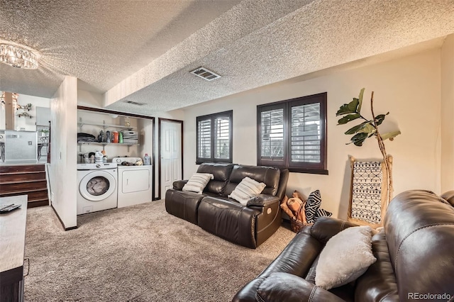 carpeted home theater featuring washer and clothes dryer and a textured ceiling