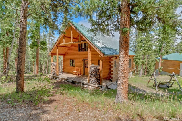 987 Boreas Cir, Jefferson, CO 80456 - view of front of house with log exterior and a metal roof