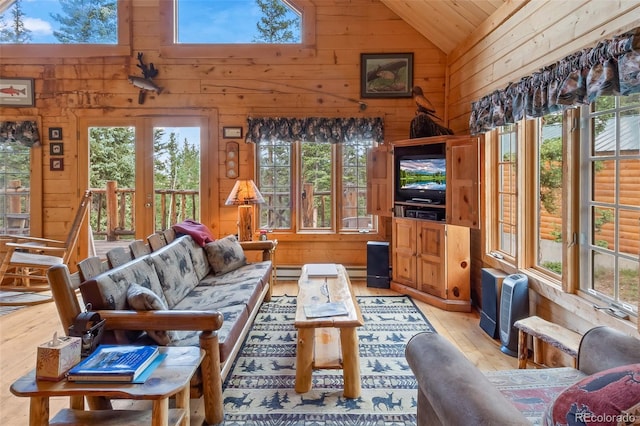 987 Boreas Cir, Jefferson, CO 80456 - living area featuring wooden walls, light wood-style floors, healthy amount of natural light, a baseboard heating unit, and high vaulted ceiling