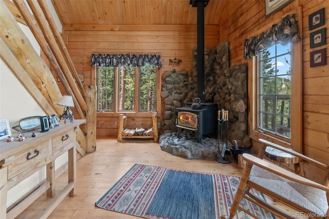 987 Boreas Cir, Jefferson, CO 80456 - sitting room with a wood stove, wooden ceiling, healthy amount of natural light, wood walls, and hardwood / wood-style floors
