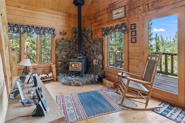 987 Boreas Cir, Jefferson, CO 80456 - living area with a wood stove, wood-type flooring, wood walls, wood ceiling, and vaulted ceiling