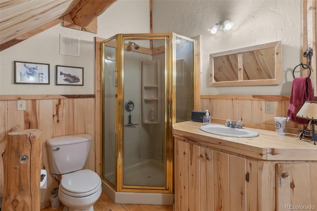 987 Boreas Cir, Jefferson, CO 80456 - full bath with a stall shower, vaulted ceiling, vanity, wooden walls, and a wainscoted wall