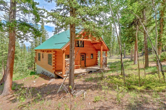 987 Boreas Cir, Jefferson, CO 80456 - rear view of house with log siding and a metal roof