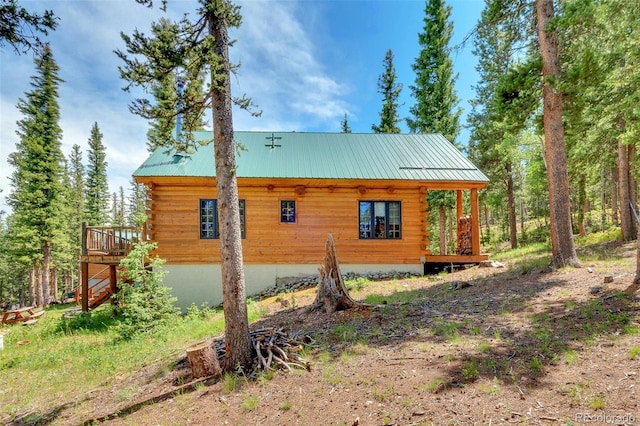 987 Boreas Cir, Jefferson, CO 80456 - view of side of home with log exterior, a deck, and a metal roof