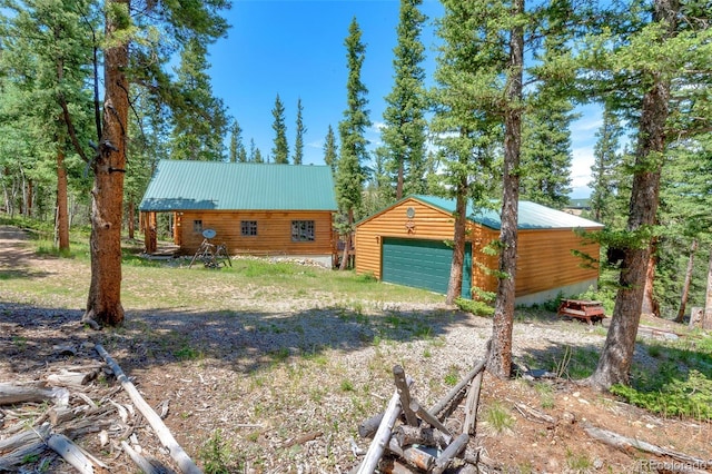 987 Boreas Cir, Jefferson, CO 80456 - view of front of home with a detached garage, an outdoor structure, and a metal roof