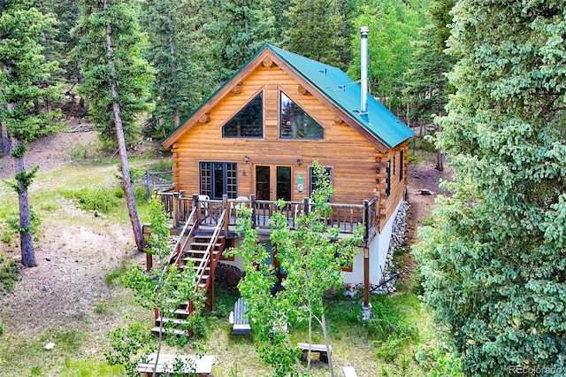987 Boreas Cir, Jefferson, CO 80456 - view of front of home featuring log siding, stairs, a deck, and a view of trees