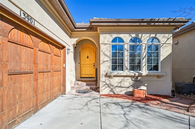 property entrance with stucco siding