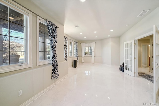 hallway with french doors and recessed lighting