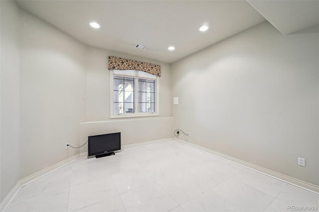 empty room with recessed lighting, marble finish flooring, and baseboards