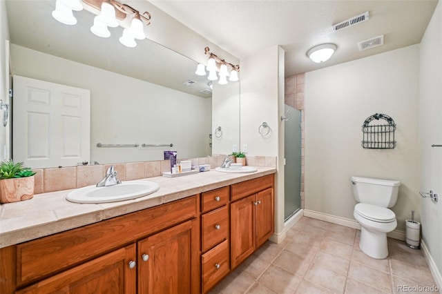 bathroom featuring double vanity, a shower stall, tile patterned flooring, and toilet