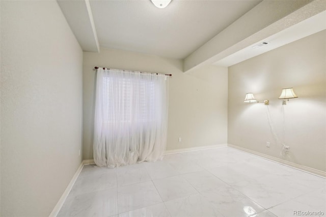 unfurnished room featuring baseboards