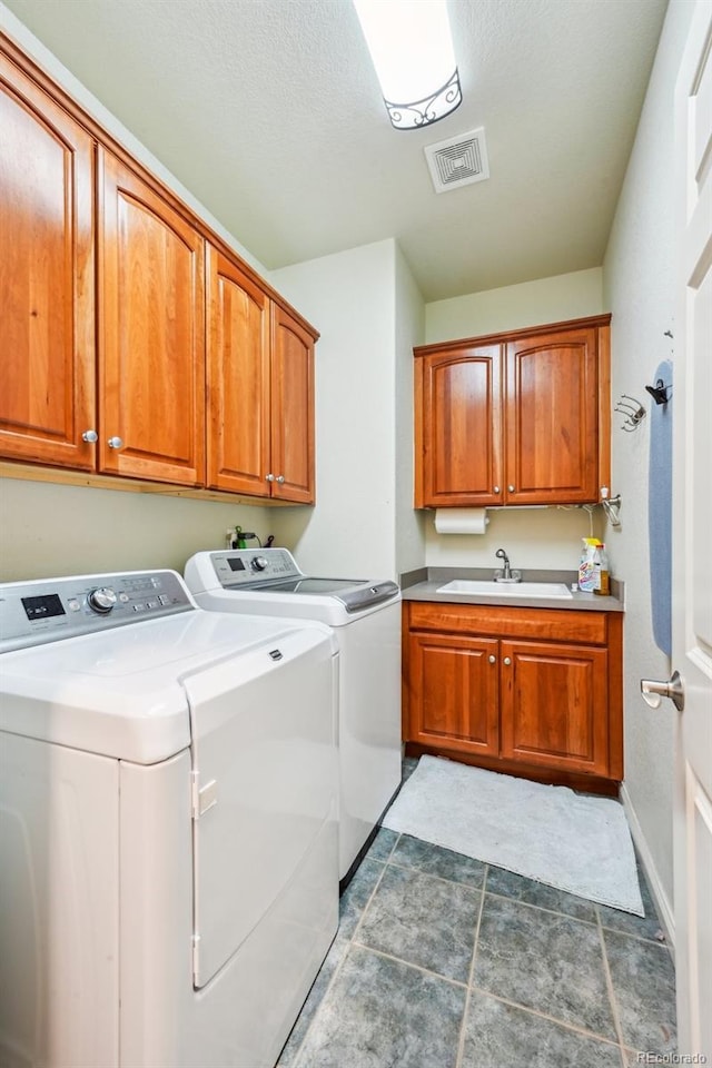 laundry room with cabinet space, washer and dryer, and baseboards