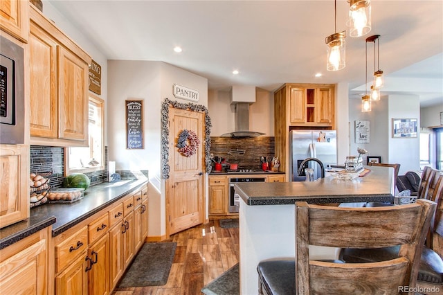 42919 Vista Rdg, Parker, CO 80138 - kitchen featuring wall chimney range hood, stainless steel appliances, dark countertops, backsplash, and recessed lighting