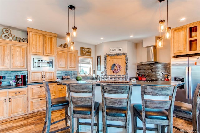 42919 Vista Rdg, Parker, CO 80138 - kitchen with wall chimney range hood, light brown cabinetry, dark countertops, and recessed lighting