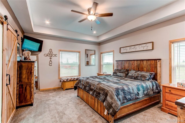 42919 Vista Rdg, Parker, CO 80138 - bedroom with a barn door, light carpet, multiple windows, a raised ceiling, and recessed lighting