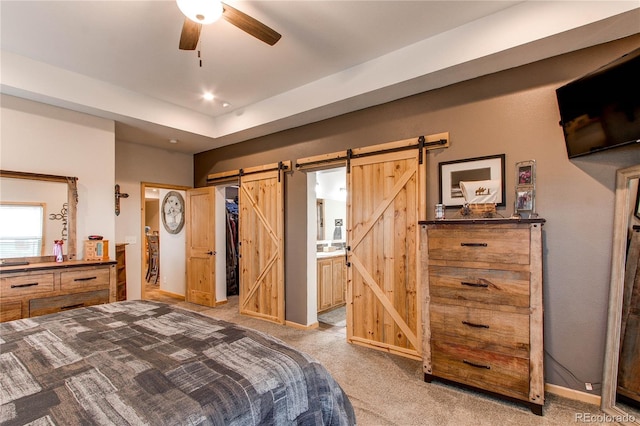 42919 Vista Rdg, Parker, CO 80138 - bedroom with a barn door, light carpet, ensuite bath, and a ceiling fan