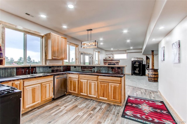 42919 Vista Rdg, Parker, CO 80138 - kitchen featuring stainless steel dishwasher, black range, light wood-style flooring, dark countertops, and a peninsula