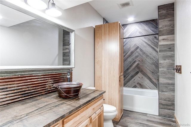 42919 Vista Rdg, Parker, CO 80138 - bathroom featuring vanity, bathing tub / shower combination, and wood finished floors