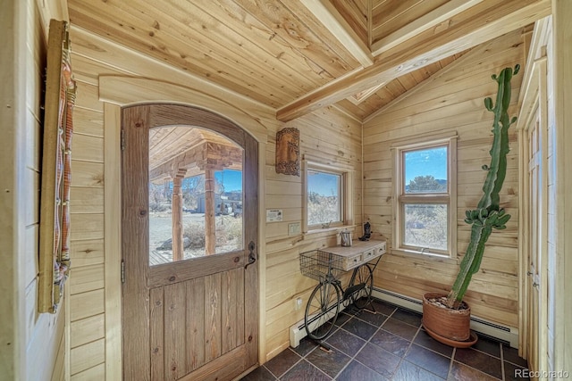 entryway with a baseboard radiator, wooden ceiling, vaulted ceiling, and wooden walls