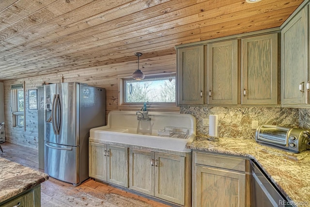 kitchen with pendant lighting, wooden walls, light stone countertops, light wood-type flooring, and stainless steel fridge with ice dispenser