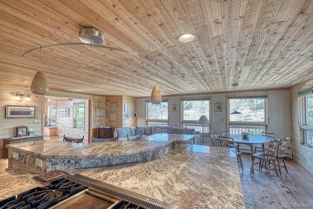 kitchen with stone countertops, wooden ceiling, and vaulted ceiling