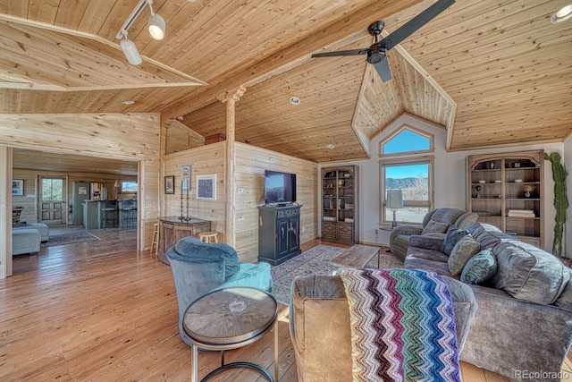 living room with wood walls, light hardwood / wood-style flooring, high vaulted ceiling, and wooden ceiling